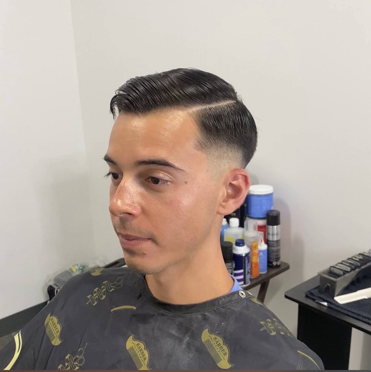 Hard part comb over with a skin fade